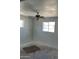 Bedroom with ceiling fan, two windows, and unfinished flooring at 3419 W Glenn Dr, Phoenix, AZ 85051