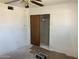 Bright bedroom features ceiling fan and closet with sliding door at 3419 W Glenn Dr, Phoenix, AZ 85051