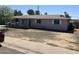Single story home with overgrown yard and covered front porch at 3419 W Glenn Dr, Phoenix, AZ 85051
