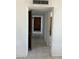 Hallway with tile flooring and a built-in wooden cabinet at the end at 3419 W Glenn Dr, Phoenix, AZ 85051