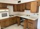 Kitchen showcases wood cabinets, white countertop, and tile flooring at 3419 W Glenn Dr, Phoenix, AZ 85051
