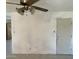 Open living area with tiled floors, white walls and a ceiling fan at 3419 W Glenn Dr, Phoenix, AZ 85051