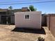 Backyard shed structure with a single window on a sunny day at 3419 W Glenn Dr, Phoenix, AZ 85051