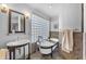 Charming bathroom featuring a classic clawfoot tub, pedestal sink, and vintage-style fixtures for a luxurious feel at 3623 S Agave Way, Chandler, AZ 85248