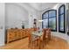 Well-lit dining room featuring wood floors, arched windows and modern light fixture at 3623 S Agave Way, Chandler, AZ 85248