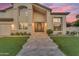 Stunning front elevation showcasing a grand entrance with a decorative door and manicured green lawn at 3623 S Agave Way, Chandler, AZ 85248