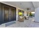 Inviting front porch with ornate metal doors and comfortable seating area at 3623 S Agave Way, Chandler, AZ 85248