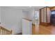 Bright hallway with hardwood floors and white walls, leading to a bedroom with a Japanese-style sliding door at 3623 S Agave Way, Chandler, AZ 85248