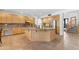 Open kitchen featuring wood cabinets and floors, stainless appliances, and island at 3623 S Agave Way, Chandler, AZ 85248