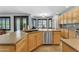 Large kitchen featuring an island, wood cabinets, stainless appliances and tile flooring at 3623 S Agave Way, Chandler, AZ 85248