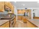 Open kitchen showcasing wood cabinetry, stainless appliances and island at 3623 S Agave Way, Chandler, AZ 85248