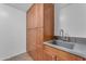 Laundry room with ample wooden cabinet space and utility sink at 3623 S Agave Way, Chandler, AZ 85248
