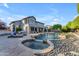 Stunning backyard pool and spa with rock features and ample lounge space at 3623 S Agave Way, Chandler, AZ 85248