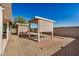 Backyard features desert landscaping, patio with barbeque grill, and covered patio at 3885 E Lambeth Pl, San Tan Valley, AZ 85140