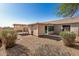 View of the home's backyard with desert landscaping and private covered patio, ideal for outdoor relaxation at 3885 E Lambeth Pl, San Tan Valley, AZ 85140