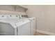 Dedicated laundry room area with stacked washer and dryer units at 3885 E Lambeth Pl, San Tan Valley, AZ 85140