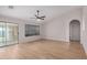 Open living room featuring wood floors, fan and sliding glass doors for optimal natural light at 3885 E Lambeth Pl, San Tan Valley, AZ 85140