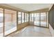 Well-lit patio with seamless floor, windows, and outdoor access at 3885 E Lambeth Pl, San Tan Valley, AZ 85140