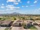 Beautiful aerial view of a community with golf course and mountain backdrop on a sunny day, Arizona real estate at 3933 E Meadowview Dr, Gilbert, AZ 85298