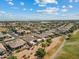 Expansive aerial view of a residential neighborhood with well-maintained homes, desert landscaping, and a community golf course at 3933 E Meadowview Dr, Gilbert, AZ 85298