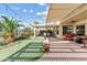 This backyard features a covered patio, outdoor putting green, and beautiful landscaping at 3933 E Meadowview Dr, Gilbert, AZ 85298