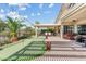 This backyard features a covered patio, outdoor putting green, and beautiful landscaping at 3933 E Meadowview Dr, Gilbert, AZ 85298