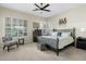Comfortable bedroom with a queen-size bed, zebra print accent chair, and ample natural light from large windows at 3933 E Meadowview Dr, Gilbert, AZ 85298