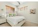 Charming bedroom with a white bed frame, decorative pillows, and three windows providing ample sunlight at 3933 E Meadowview Dr, Gilbert, AZ 85298