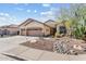 Charming home featuring a three-car garage and a beautifully xeriscaped front yard at 3933 E Meadowview Dr, Gilbert, AZ 85298