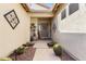 Inviting front entrance with desert plants, decorative details, and a covered walkway leading to the front door at 3933 E Meadowview Dr, Gilbert, AZ 85298