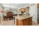 Open-concept kitchen featuring a large island, wooden cabinetry, and view of the dining and living areas at 3933 E Meadowview Dr, Gilbert, AZ 85298