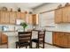 Well-equipped kitchen featuring wooden cabinets, granite countertops, and a center island with seating at 3933 E Meadowview Dr, Gilbert, AZ 85298