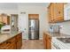 Spacious kitchen offering wooden cabinets, stainless steel refrigerator, granite countertops, and modern appliances at 3933 E Meadowview Dr, Gilbert, AZ 85298