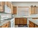 Modern kitchen boasting wooden cabinetry, stainless steel appliances, granite countertops, and tiled backsplash at 3933 E Meadowview Dr, Gilbert, AZ 85298