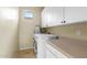 Functional laundry room featuring a washer, dryer, storage cabinets, and a folding counter at 3933 E Meadowview Dr, Gilbert, AZ 85298