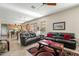 Inviting living room with dark leather sofas, decorative rug, and neutral walls, creating a cozy atmosphere at 3933 E Meadowview Dr, Gilbert, AZ 85298