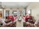 Bright living room with large windows, comfortable seating arrangement, neutral carpet, and views of the outdoor space at 3933 E Meadowview Dr, Gilbert, AZ 85298