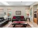 Comfortable living room featuring a dark leather sofa, bright natural light, and neutral decor for relaxing at 3933 E Meadowview Dr, Gilbert, AZ 85298