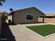 Gravel backyard area with a patch of synthetic grass and views of the home's rear and a privacy fence at 40800 W Rio Grande Dr, Maricopa, AZ 85138
