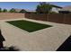 Low maintenance backyard features an artificial turf area surrounded by gravel, enclosed by a block wall fence at 40800 W Rio Grande Dr, Maricopa, AZ 85138