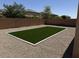 This backyard features an artificial turf area surrounded by gravel, perfect for outdoor enjoyment at 40800 W Rio Grande Dr, Maricopa, AZ 85138
