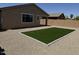 Backyard with gravel landscaping surrounding the artificial turf, offering a clean and modern outdoor living space at 40800 W Rio Grande Dr, Maricopa, AZ 85138