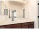 Bathroom vanity with dark wood cabinets and a large mirror at 40800 W Rio Grande Dr, Maricopa, AZ 85138