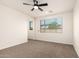 Bedroom featuring neutral carpet and a window looking onto the neighborhood at 40800 W Rio Grande Dr, Maricopa, AZ 85138