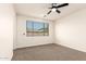 Bedroom featuring neutral carpet and a large window with venetian blinds at 40800 W Rio Grande Dr, Maricopa, AZ 85138