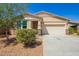 Beautiful one-story home featuring stone accents and a well-maintained lawn with desert landscaping at 40800 W Rio Grande Dr, Maricopa, AZ 85138