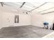 A well-lit garage with a water heater and a blue grill at 40800 W Rio Grande Dr, Maricopa, AZ 85138