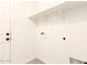Bright laundry room with tile floors, shelf, and modern hookups at 40800 W Rio Grande Dr, Maricopa, AZ 85138