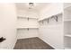 Spacious walk-in closet with shelves, ample storage, and neutral carpeting at 40800 W Rio Grande Dr, Maricopa, AZ 85138