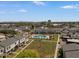 Aerial view of the community pool, green spaces, and surrounding residential buildings at 418 E Woodman Dr, Tempe, AZ 85283